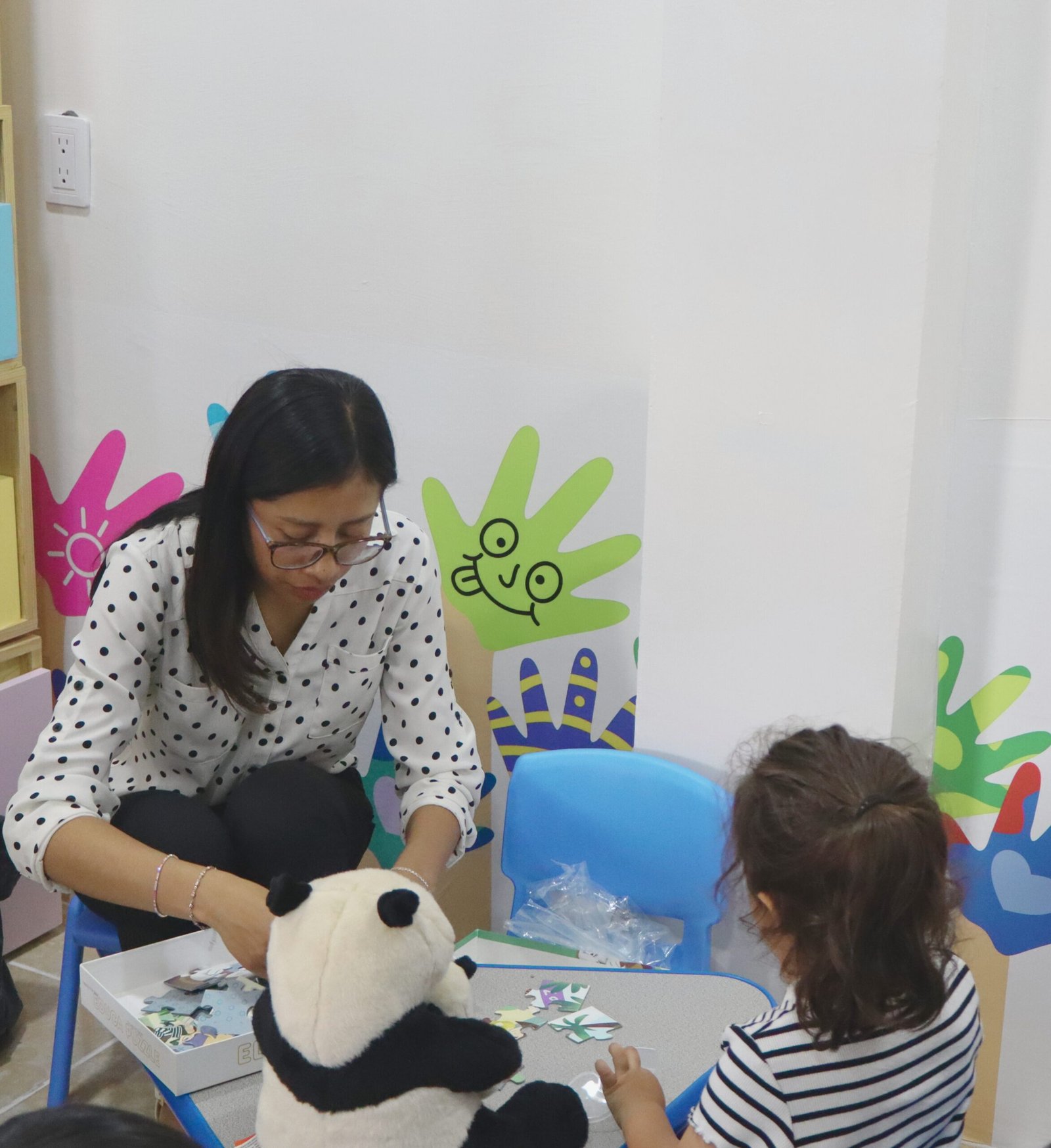 A stylish woman surrounded by bright blue smoke outdoors, creating a dynamic fashion statement.