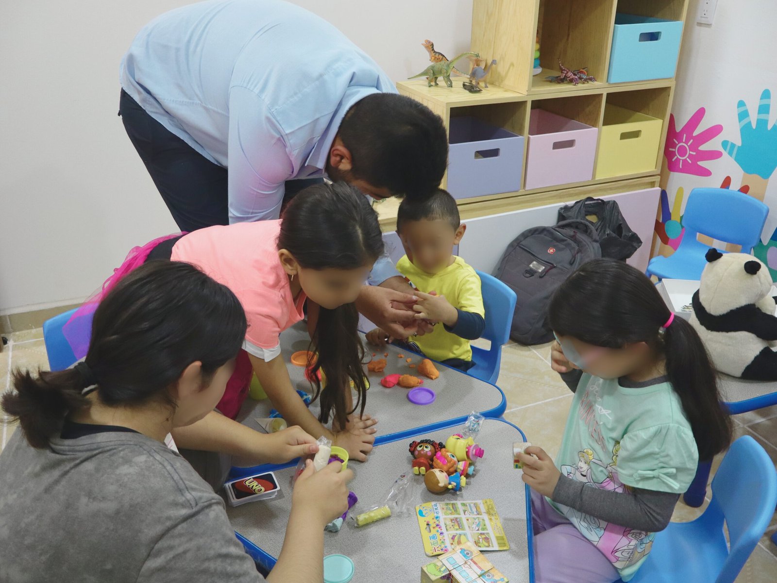 A stylish woman surrounded by bright blue smoke outdoors, creating a dynamic fashion statement.